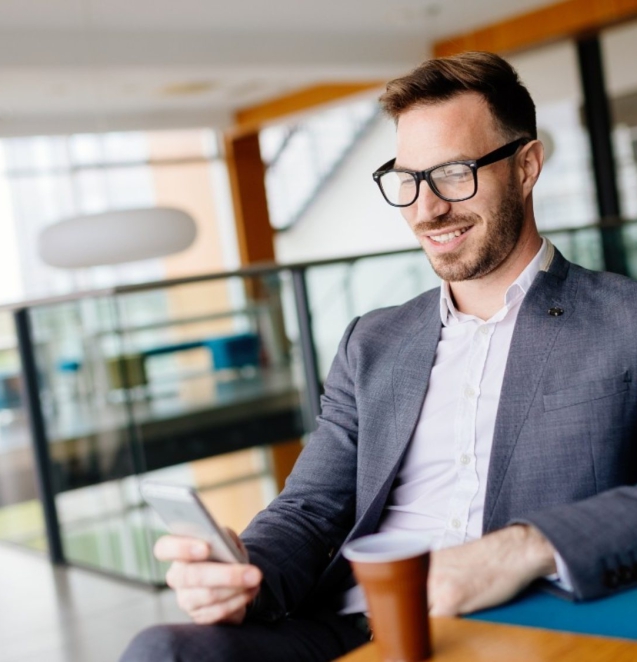 businessman-taking-a-break-with-a-cup-of-coffee-JW4B3DH-2000x1125